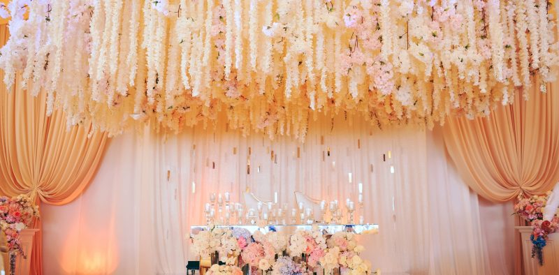 groom and bride's wedding table decorated with flowers and candl