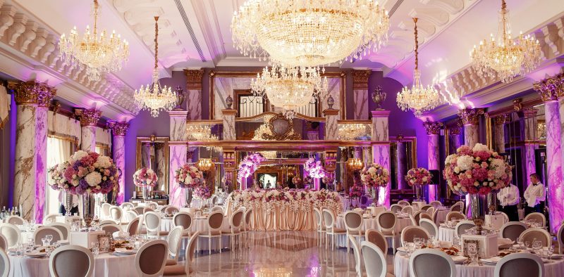 Luxurious dinner hall with large crystal chandeliers hanging fro